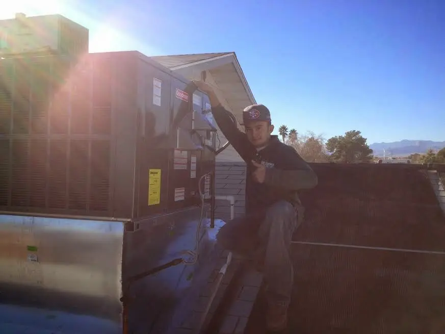 HVAC technician performing HVAC Inspection on a rooftop unit in Kanab